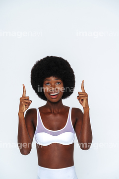 Afro-American skinny woman wearing lingerie with arms crossed