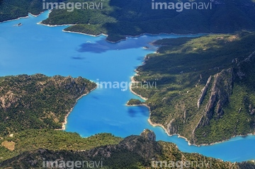 A paraglider nears the landing zone above Phewa lake in Nepal