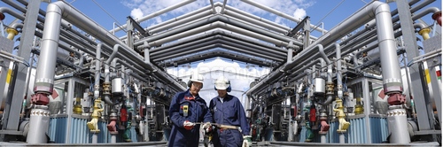 Oil refinery workers and pipework