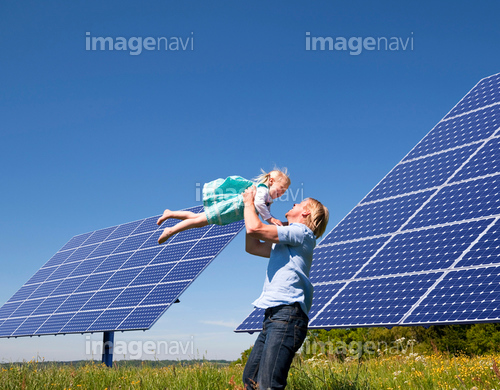 Father and daughter by solar panels