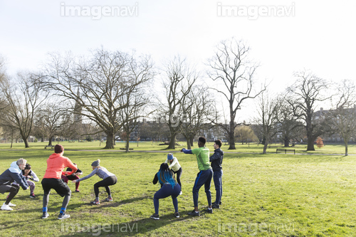 People exercising in sunny park