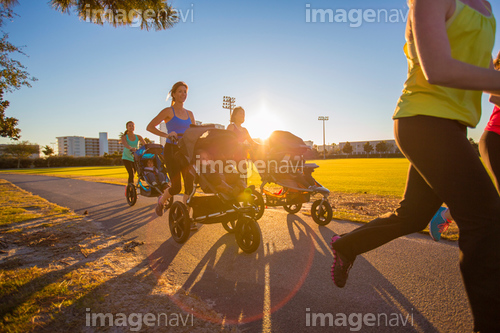 Mothers jogging in park with pushchairs