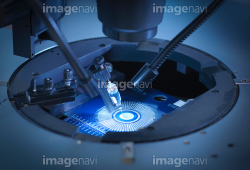Machine checking silicon wafers in clean room laboratory, close up