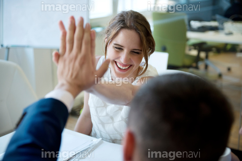 Happy businesswoman and businessman high fiving