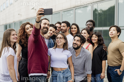 Man taking selfie with group of friends in city